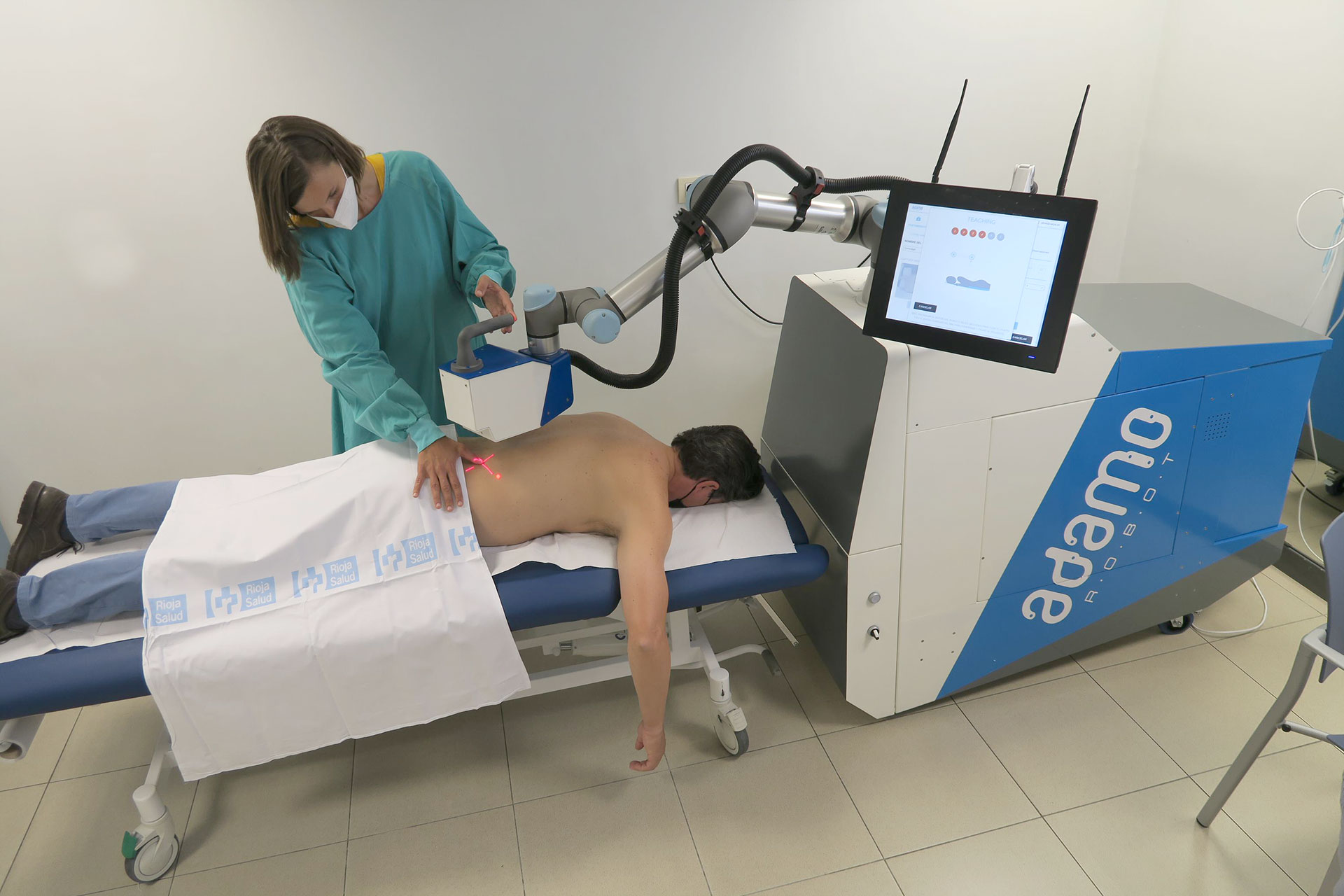 Adamo treating a patient's back with pressurized air, without contact